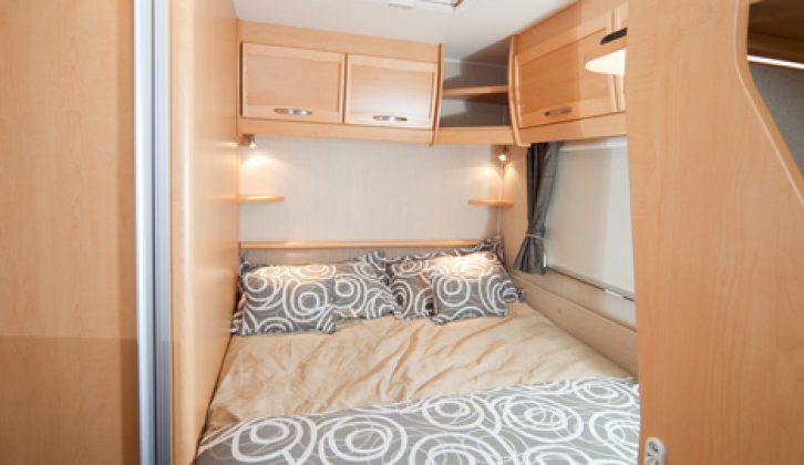 The rear fixed bed has a padded headboard, comfy mattress and reading lights