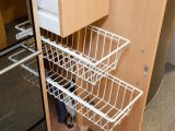 Pull-out wire shelves make the most of narrow cupboard space