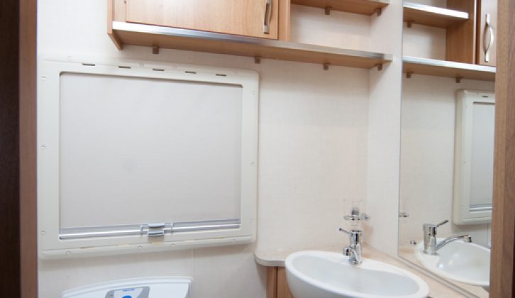 Nearside washroom has ample legroom around toilet and good storage, – read Practical Caravan's expert review of the 2010 Coachman Laser 650/4