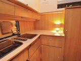 Storage space abounds in the corner kitchen of the Trigano Silver 310 TL pop-top caravan reviewed by the experts at Practical Caravan