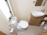 There is plenty of legroom by the swivel toilet, while a towel ring and coat hook are welcome