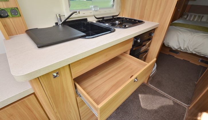 The black-enamel sink and hob, large worktop and huge drawers make the kitchen attractive and practical