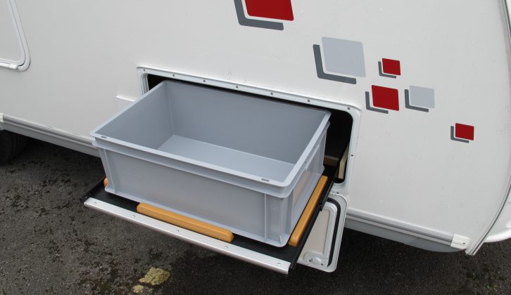 Access to the under-bed storage area includes a slide-out bin