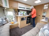 An L-shaped lounge creates more space in the kitchen area of the van