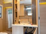 The washroom is a little on the narrow side, but features a large vanity unit, good storage and stylish tap and basin
