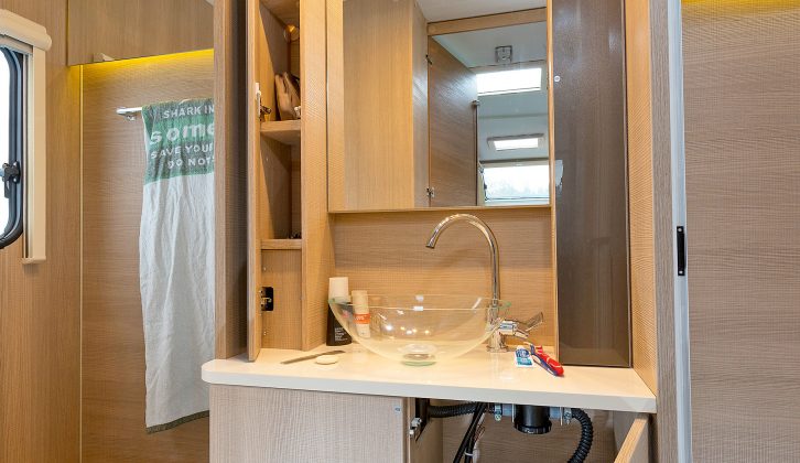 The washroom is a little on the narrow side, but features a large vanity unit, good storage and stylish tap and basin