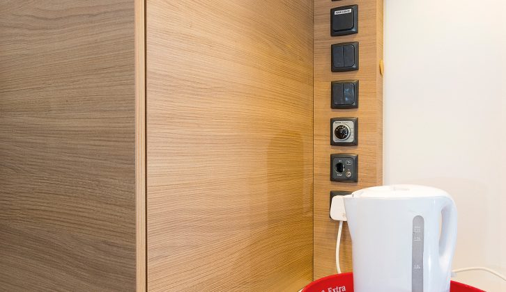 The dresser by the entry door sits beneath a bank of controls