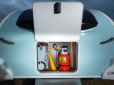 A small, square front locker is organised to hold gas cylinders and kit