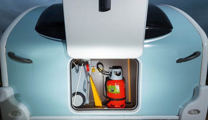 A small, square front locker is organised to hold gas cylinders and kit