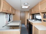 The nearside kitchen of the 2013 Elddis Xplore 505, reviewed by Practical Caravan, is across the offside dinette; the dresser can serve as a TV stand or extra worktop