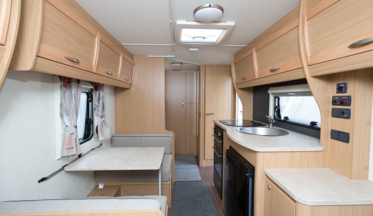 The nearside kitchen of the 2013 Elddis Xplore 505, reviewed by Practical Caravan, is across the offside dinette; the dresser can serve as a TV stand or extra worktop