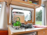 Sterckeman Alizé 370CE kitchen has a three-burner hob, sink, dual-fuel fridge with freezer and three large drawers