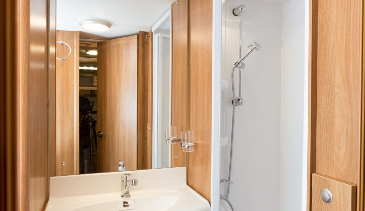 Washroom is snug but works well with storage below the basin, a good mirror and separate shower unit. Table storage is here