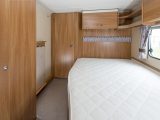 The fixed double bed in the Sprite Quattro EW is surrounded by storage, including a large wardrobe, lockers and a large bed box that you can access without scraping your knuckles as you lift the base and mattress, say Practical Caravan's reviewers