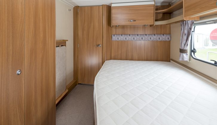 The fixed double bed in the Sprite Quattro EW is surrounded by storage, including a large wardrobe, lockers and a large bed box that you can access without scraping your knuckles as you lift the base and mattress, say Practical Caravan's reviewers