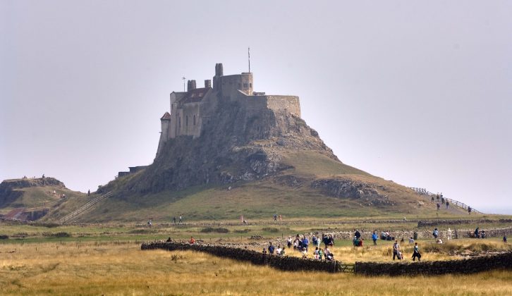 The dramatic profile of Lindisfarne Castle dominates the scene above Holy Island and is a must-see on caravan holidays in Northumberland