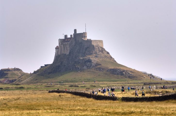The dramatic profile of Lindisfarne Castle dominates the scene above Holy Island and is a must-see on caravan holidays in Northumberland