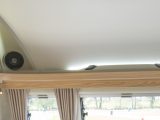 Speakers and lights share space above the Coachman Vision 580/5's front open shelf with a mains socket, say Practical Caravan's reviewers