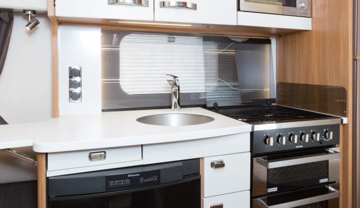 The cabinet doors in the Swift Elegance 570’s kitchen get cream facings to differentiate them from the lounge's lockers