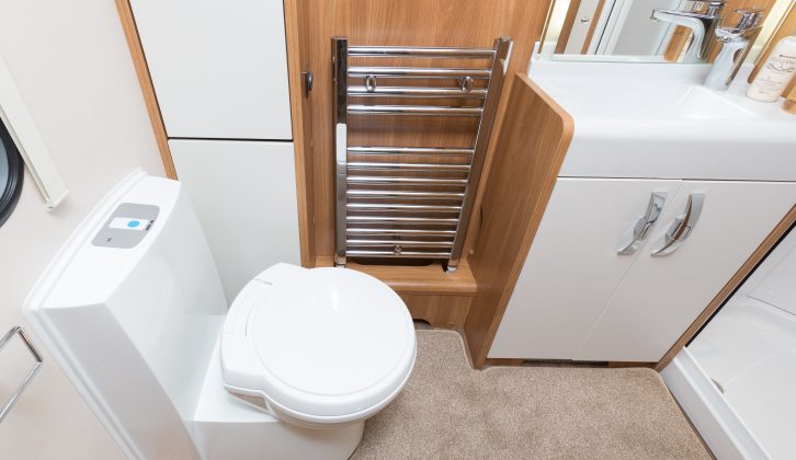 The Swift Elegance 570's washroom is fitted with an electric flush toilet, radiator-towel rail, basin and vanity unit, and a fully lined shower