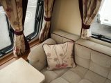The curtains and cushions add a floral touch to the decor of the Elddis Affinity 554, which also has 'Chivago' upholstery fabric with purple piping
