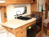 The Elddis Affinity 554's kitchen looks upmarket, with its attractive cabinet work, full battery of appliances and plethora of work and storage space, says Practical Caravan