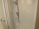 The large shower in the Elddis Affinity 554 boasts a bi-fold door and Ecocamel Orbit showerhead, note the reviewers from Practical Caravan