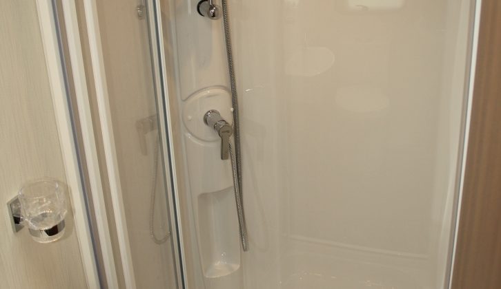 The large shower in the Elddis Affinity 554 boasts a bi-fold door and Ecocamel Orbit showerhead, note the reviewers from Practical Caravan