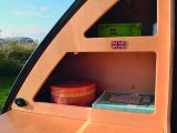 Storage space in the Standard Pod is limited but well thought-out, as in these kitchenette cubbies – read more in the Practical Caravan review