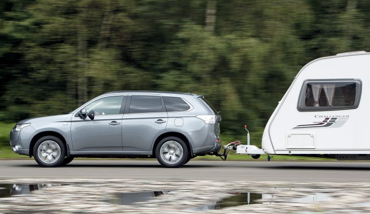 At motorway speeds, the Mitsubishi Outlander PHEV holds a straight course and needs little steering input – read more in the Practical Caravan review