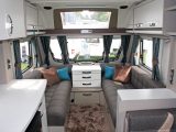 There's a light and spacious lounge in the Sterling Eccles Sport 524, with a comfy loose rug on the floor, practical plain brown upholstery, four reading spotlights and a panoramic sunroof