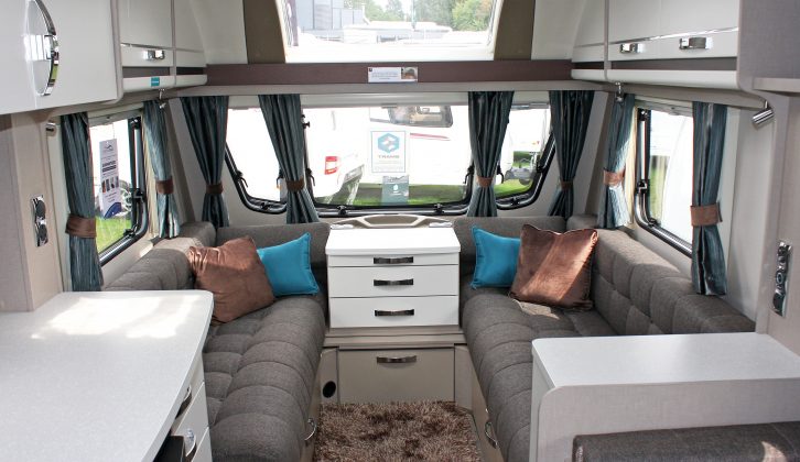 There's a light and spacious lounge in the Sterling Eccles Sport 524, with a comfy loose rug on the floor, practical plain brown upholstery, four reading spotlights and a panoramic sunroof