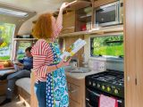 The offside kitchen in the Bailey Unicorn III Valencia has soft-close overhead lockers, a lift-out drainer and a fold-up flap adjacent to the lounge, to extend the work surface area