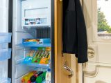 In the kitchen, beside the habitation door, is a huge 133-litre Dometic fridge/freezer, a hob with three gas burners and electric hotplate, separate oven and grill, microwave, smoke alarm and carbon monoxide detector