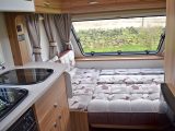 The Elddis Sanremo 304 cararan's L-shaped lounge seating turns into a double bed measuring 2.01m x 1.32m