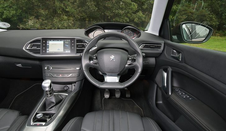 The 2015 Peugeot 308 SW has an unusually small steering wheel, but you soon get used to it, and the cabin is stylish and uncluttered