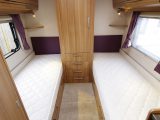 The 2015 Lunar Lexon 590 has fixed twin beds measuring 1.87m x 0.77m each, placed either side of the wardrobe, which is a most unusual caravan layout