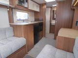 Lunar has given its 2015 Venus 460/2 caravan cream locker doors, a neutral loose-fit carpet and retro soft furnishings in this comfy lounge with long sofas you can use as twin single beds (1.86m x 0.69m) or a double bed (2.01m x 1.86m)