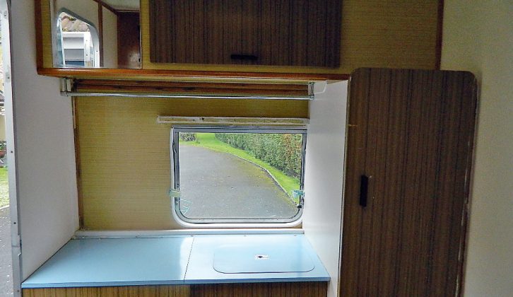 The original blue worktop was kept, but the retrofitted cupboard above it was removed