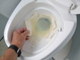 Line the bowl with a few pieces of toilet paper floating on a little flushing water if you have to do more than a pee in the caravan loo