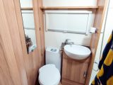 The freestanding dining table is stored in the wardrobe, but this is in the washroom, so expect to hike the length of the van before meals