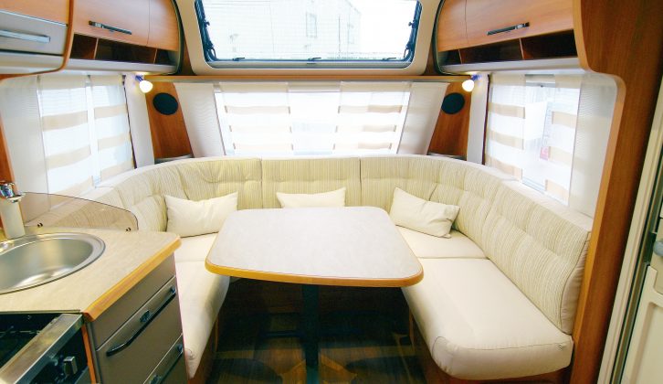 The Hymer Nova GL 590 caravan offers panoramic windows and nine spotlights to keep the lounge bright; the wraparound seating seats six, but not with the freestanding table in position