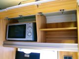 The microwave is concealed in a roof locker in the Hymer Nova GL 590