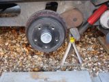 Remove the caravan wheel and make sure you have a flat-blade screwdriver handy for the next step