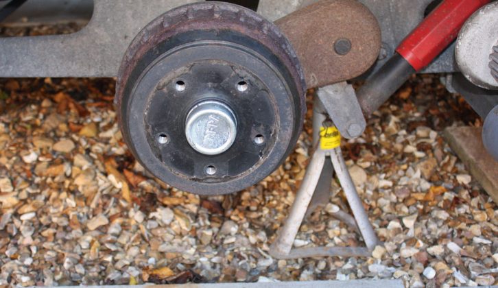 Remove the caravan wheel and make sure you have a flat-blade screwdriver handy for the next step