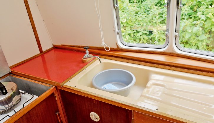 The caravan's original drainer and two-burner hob remain and are used on tour by Eileen and John