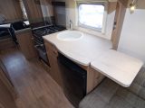 The kitchen worktop space can be extended over the sofa in the family-sized Swift Freestyle SE S 6 TD caravan