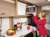 The eye-level microwave oven may be too high for some to use safely, while the fold-up flap extends the already-ample work surface. One overhead kitchen cupboard is set aside for crockery, while drawers provide an option for various types of kit and food