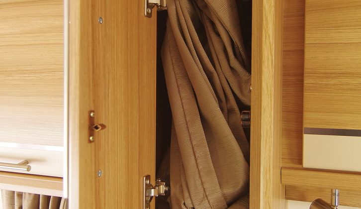 A cupboard keeps the offside bunks' privacy curtain out of the way during the day in the Quasar 646