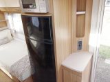 The fridge and microwave are opposite the kitchen, allowing more space for cupboards in the Lunar Delta TS